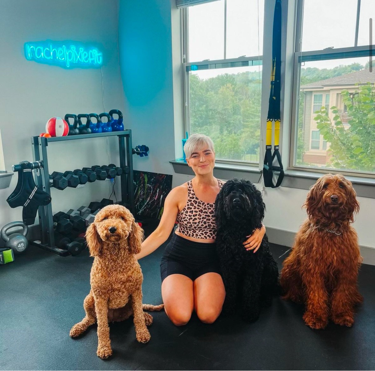 Rachel in her Nashville studio under the rachelpixiefit neon sign
